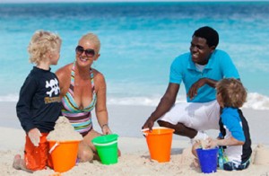 family playing on beach