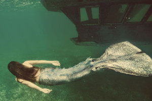 free diver in mermaid costume underwater