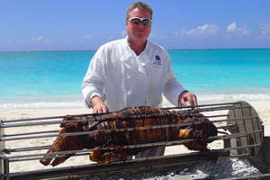 whole barbeque pig on spit with chef