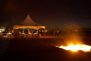 beach wedding with bonfire and tent