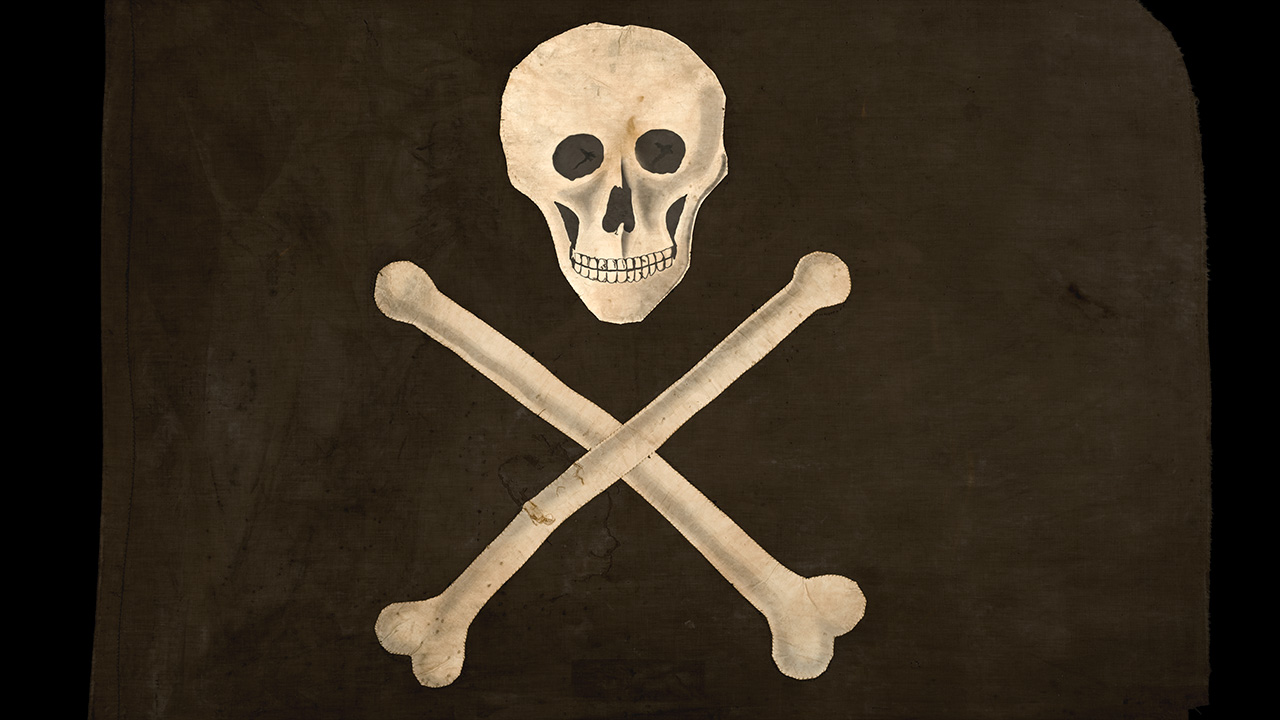 Jolly Roger Pirate Flag - By Karlsson, Anneli (color correction by Blockhaj) - https://digitaltmuseum.se/021015506485/konservator-fran-armemuseet-tittar-till-den-lanade-piratflaggan-fran-alands, CC BY 4.0, https://commons.wikimedia.org/w/index.php?curid=122327681